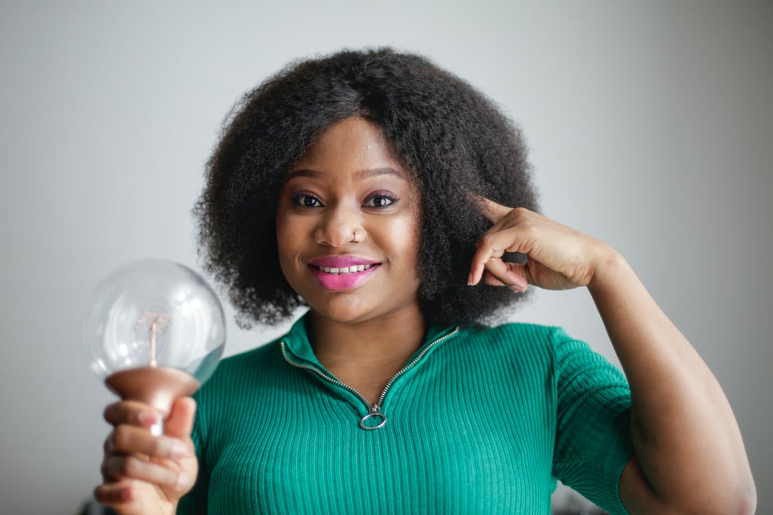 A woman holding a bulb illustrating new creative ideas