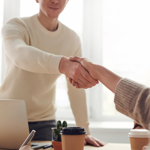 A handshake over a desk