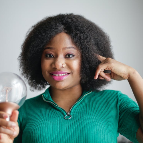 A woman holding a bulb illustrating new creative ideas