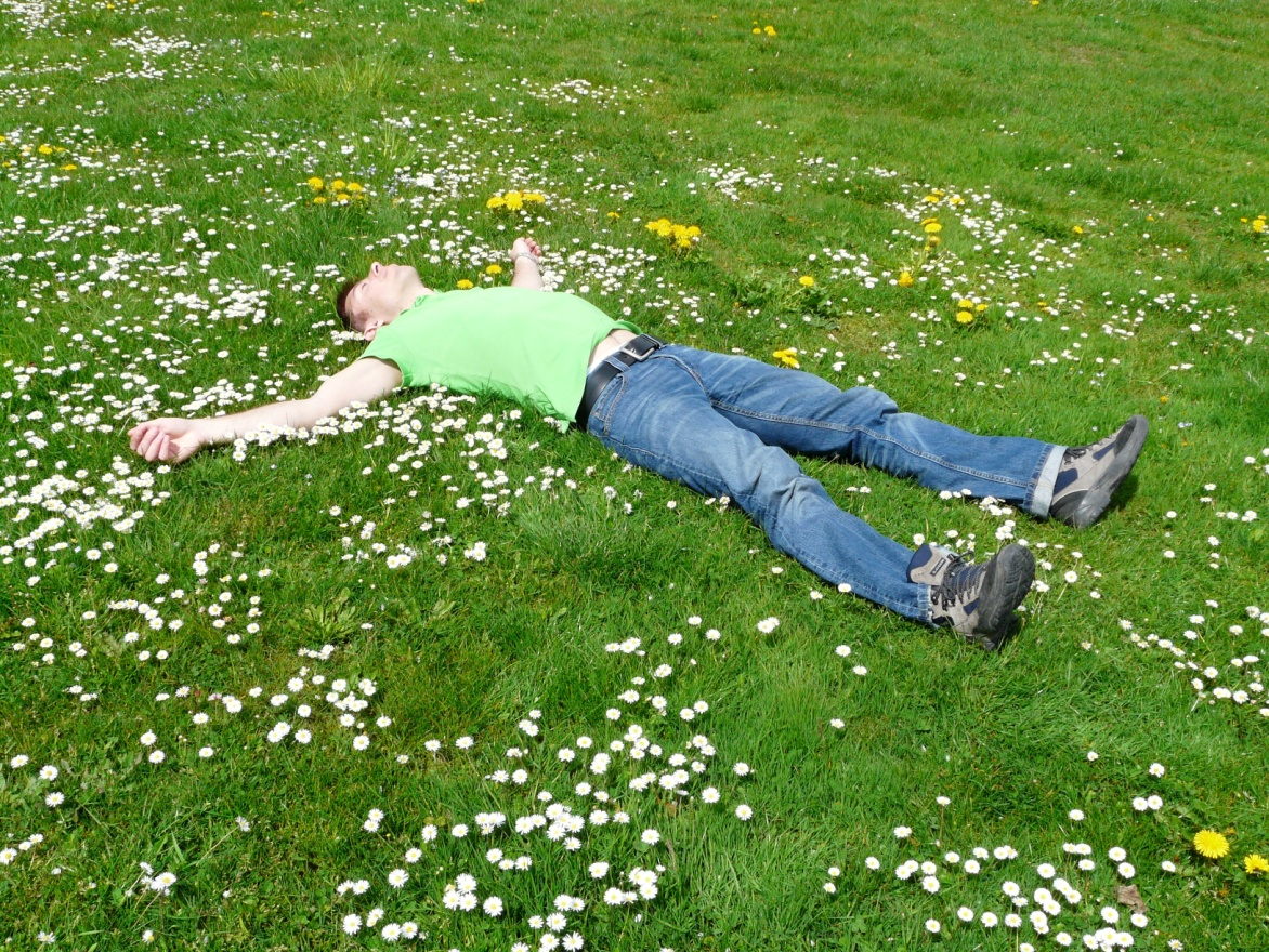 A man lies in the grass