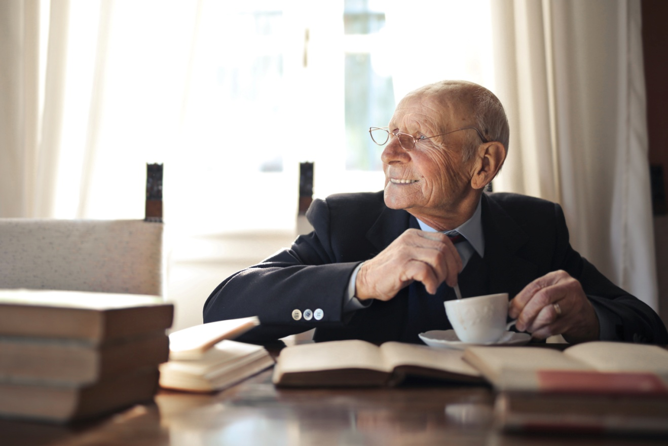 Man taking time out to read books and drink tea